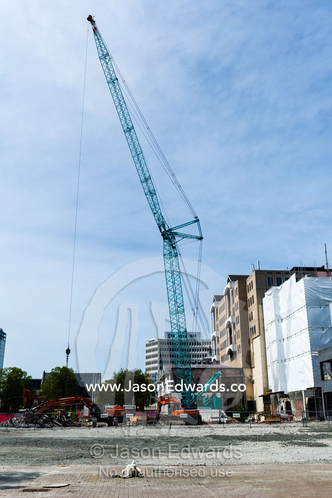A crane removes the rubble and debris from a building destroyed in an earthquake. Christchurch, South Island, New Zealand.