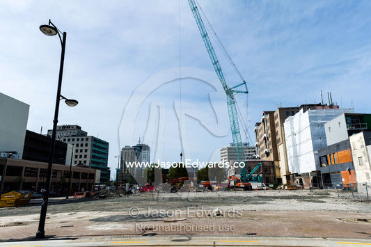 A crane removes the rubble and debris from a building destroyed in an earthquake. Christchurch, South Island, New Zealand.