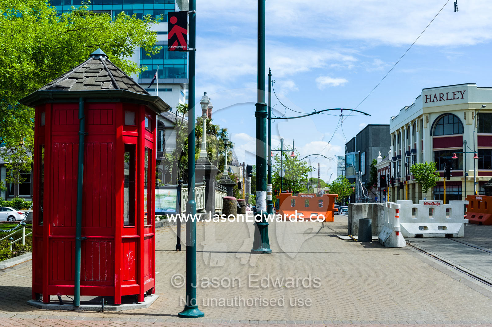 An antique bright red English telephone box near a road closure after an earthquake. Christchurch, South Island, New Zealand.