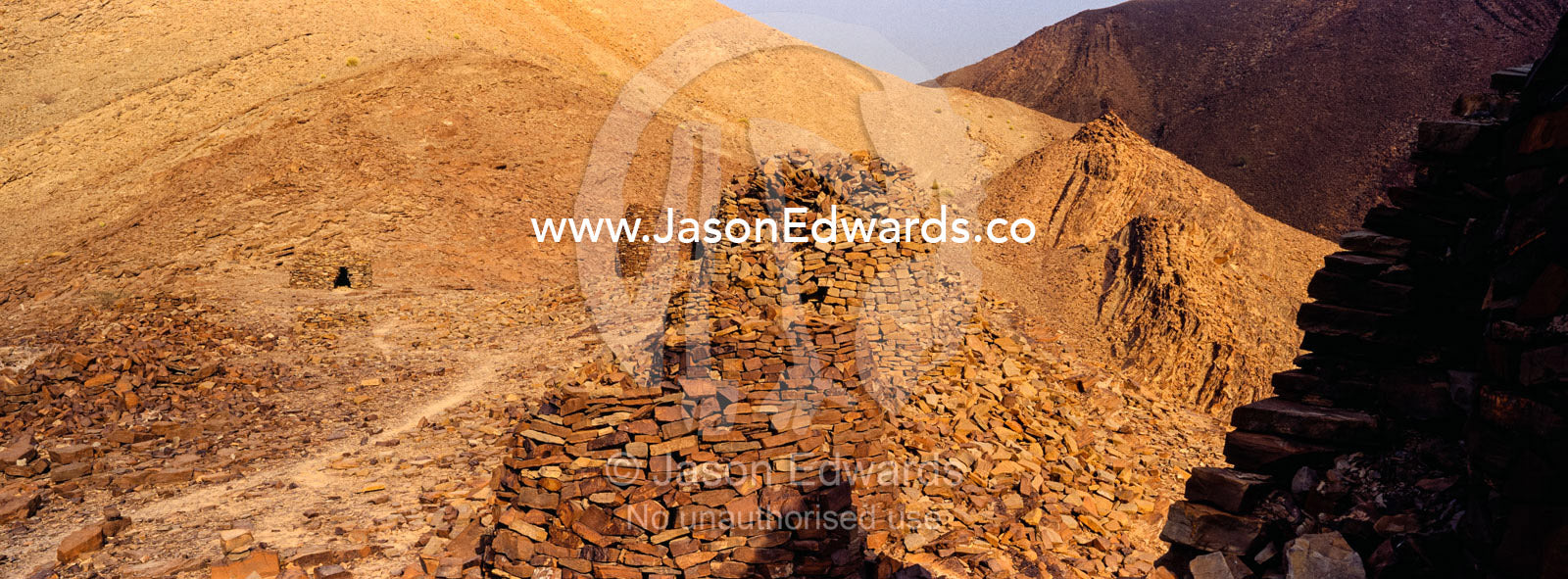 Ancient handmade stone burial mounds and tombs atop a desert ridge. Archaeological Sites of Bat, Al-Ayn, Al Dhahira Region, Sultanate of Oman.