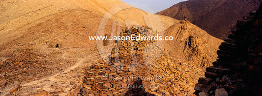 Ancient handmade stone burial mounds and tombs atop a desert ridge. Archaeological Sites of Bat, Al-Ayn, Al Dhahira Region, Sultanate of Oman.