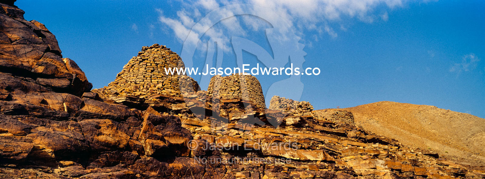 Ancient handmade stone burial mounds and tombs atop a desert ridge. Archaeological Sites of Bat, Al-Ayn, Al Dhahira Region, Sultanate of Oman.