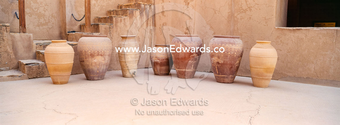 A row of clay pots used for storing food and grains in an ancient fort. Jabrin Fort, Ad Dakhiliyah Governorate, Sultanate of Oman.