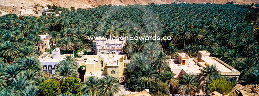 An ancient village surrounded by an irrigated plantation of date palms in a desert valley. Barkat Al Mouz, Sultanate of Oman.