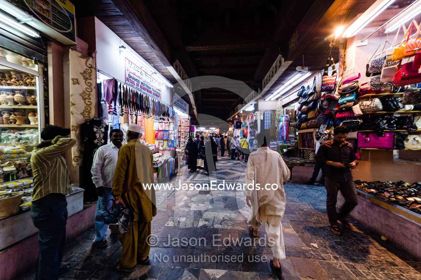 Patrons explore a night market for bargains. Mutrah Souq, Muscat, Sultanate of Oman.