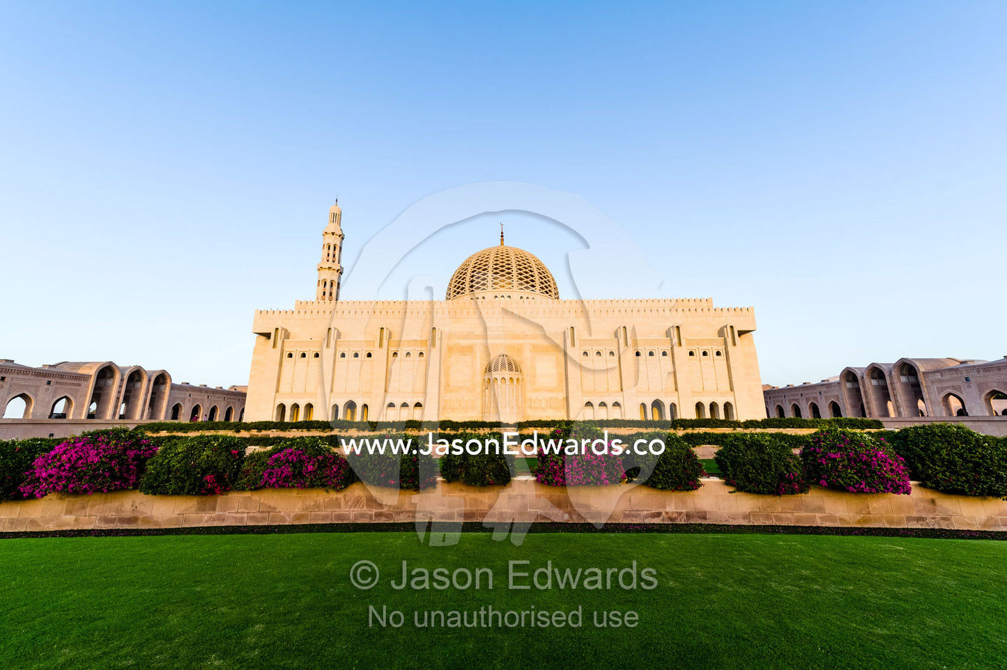 Manicured lawns and flower gardens surround the Grand Mosque. Sultan Qaboos Grand Mosque, Muscat, Sultanate of Oman.