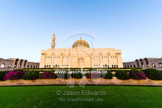 Manicured lawns and flower gardens surround the Grand Mosque. Sultan Qaboos Grand Mosque, Muscat, Sultanate of Oman.