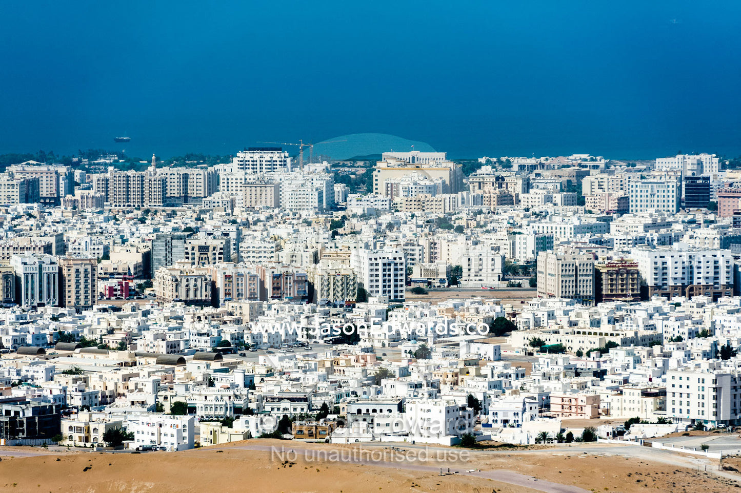 The suburbs of Muscat sprawling into the desert along the Gulf of Oman. Muscat, Gulf of Oman, Sultanate of Oman.
