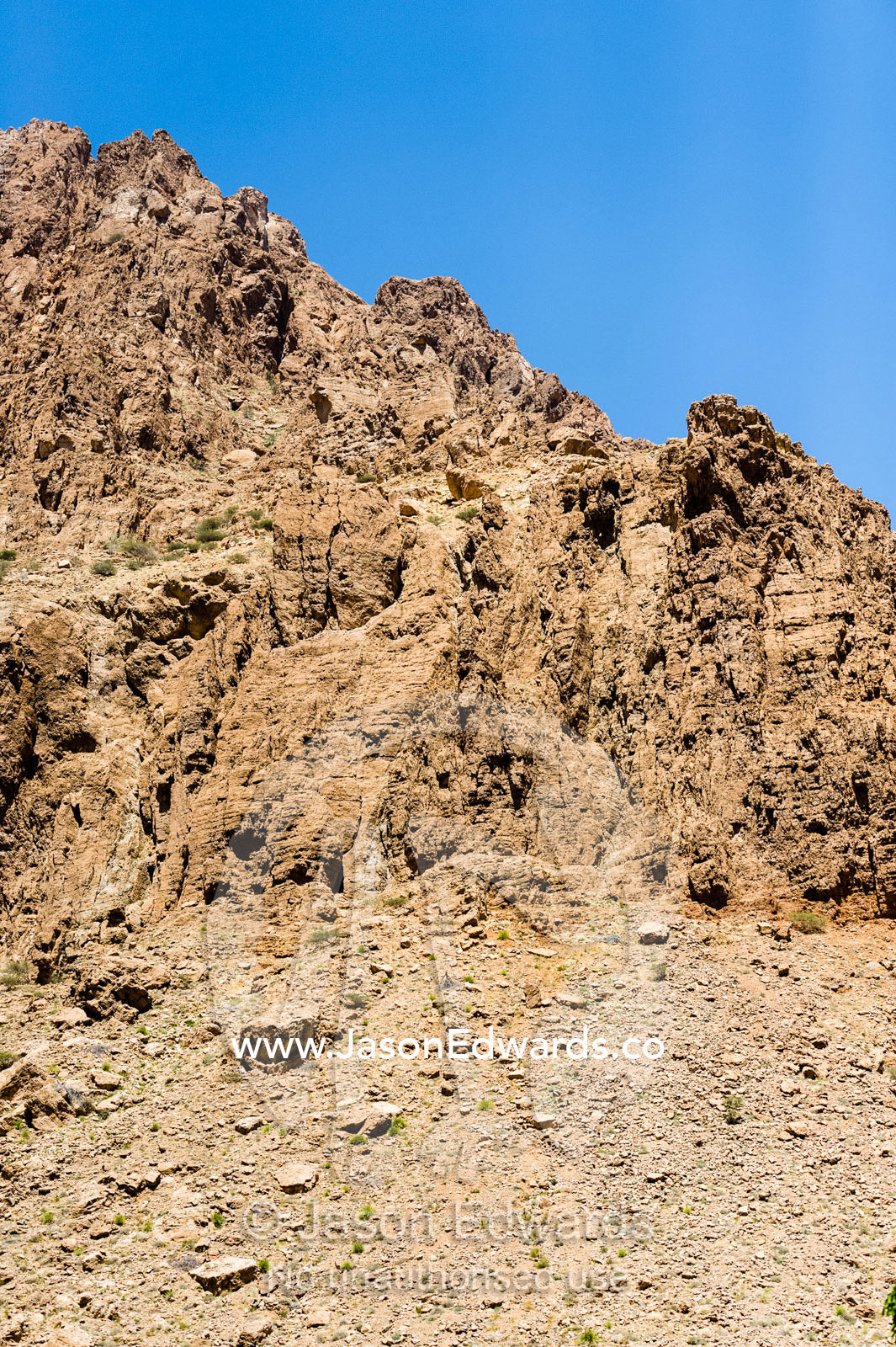 The jagged barren peaks of a rocky mountain side. Mibam, Wadi Tiwi, Sur Al Sharqiyah South Governorate, Sultanate of Oman.