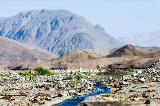 Water runs through a falaj in the desert and is used to irrigate crops and livestock in remote villages. Wadi Fanja, Dima Wal Taeen, North Al Sharqiyah Governorate, Sultanate of Oman.
