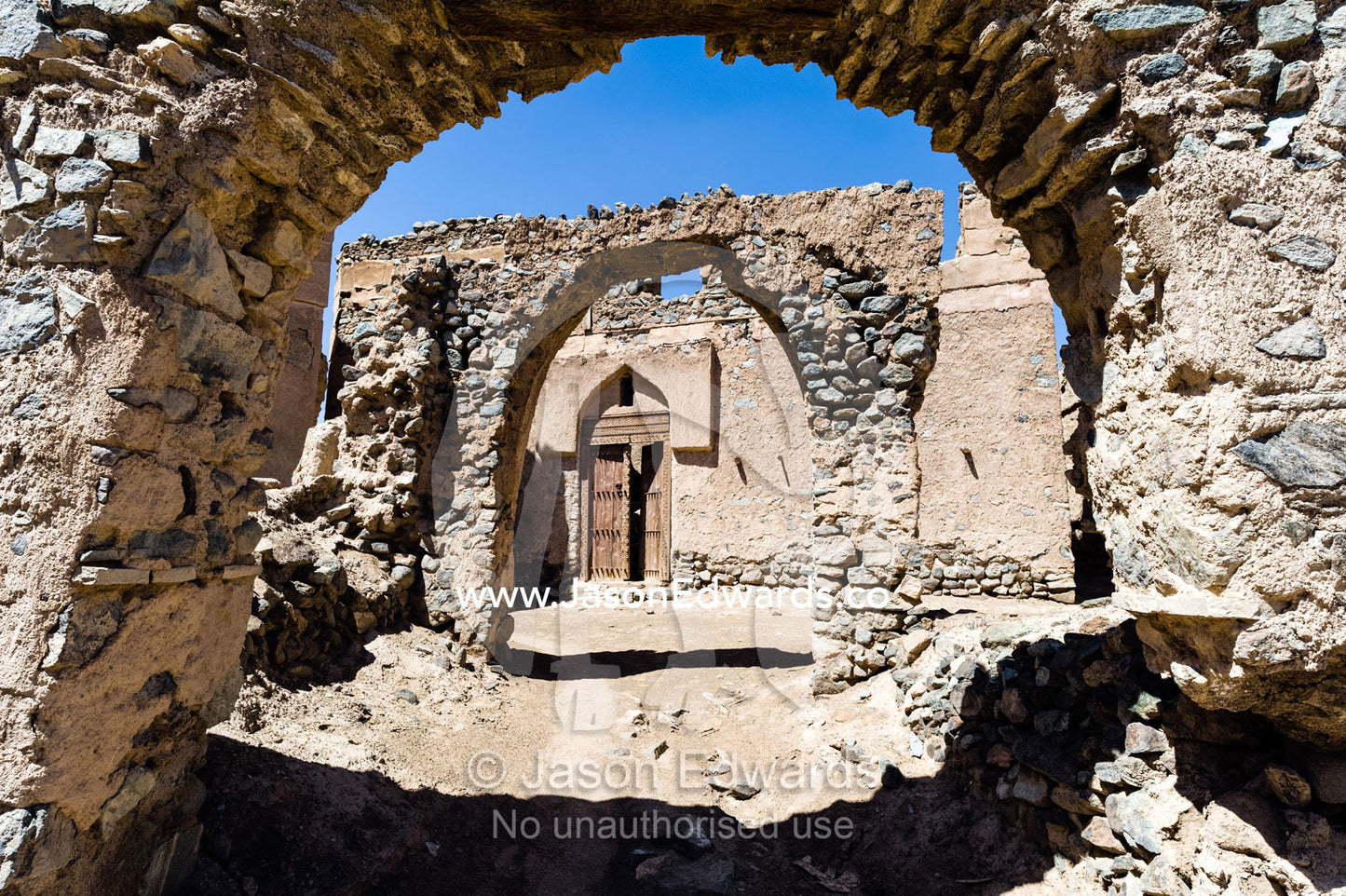 Stone and mudbrick archways in an abandoned village market in the desert. Ibra, Ash Sharqiyah Region, Sultanate of Oman.
