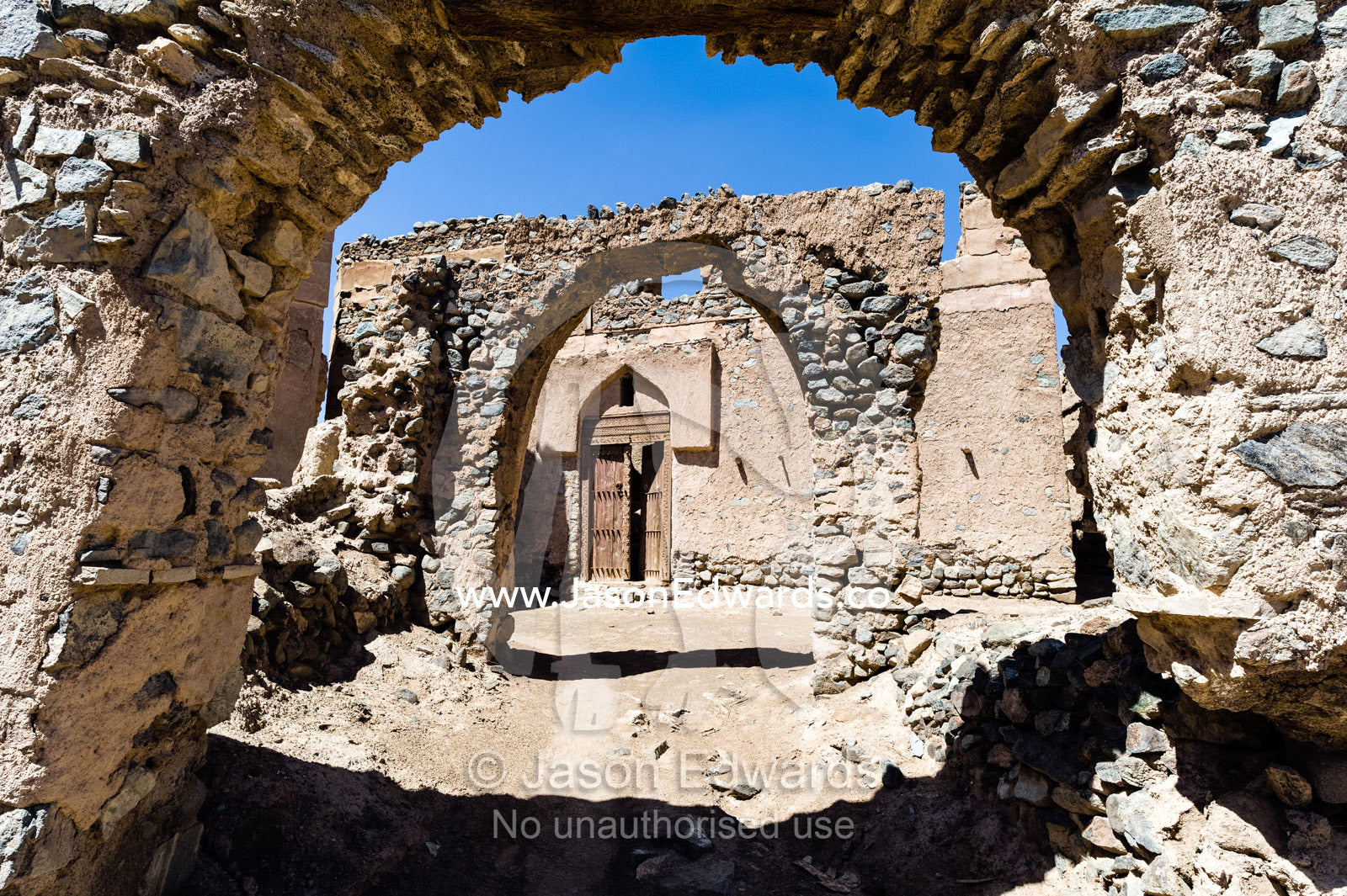 Stone and mudbrick archways in an abandoned village market in the desert. Ibra, Ash Sharqiyah Region, Sultanate of Oman.