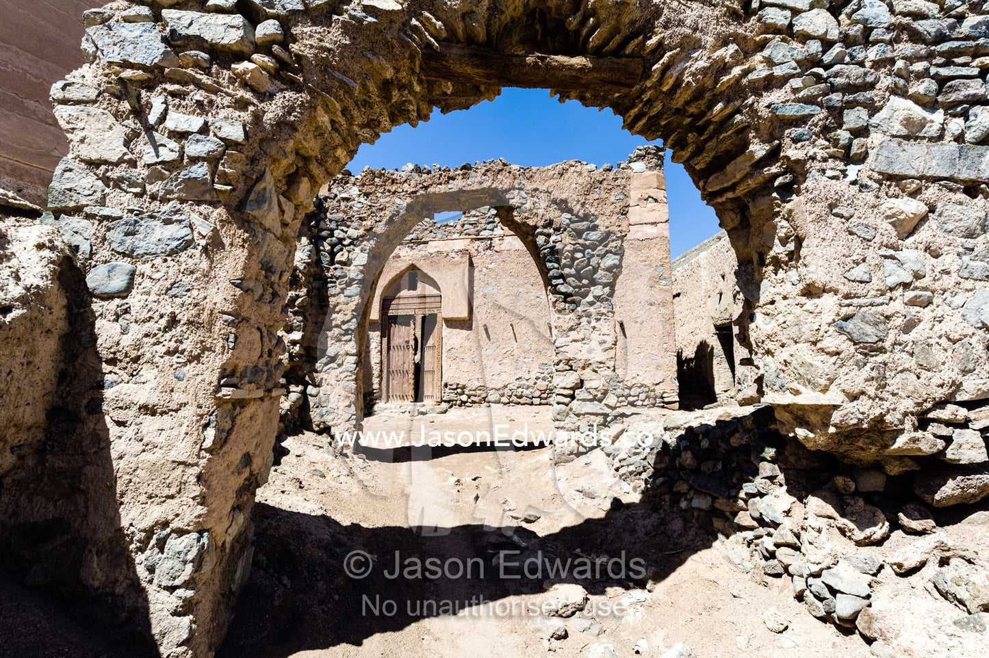 Stone and mudbrick archways in an abandoned village market in the desert. Ibra, Ash Sharqiyah Region, Sultanate of Oman.
