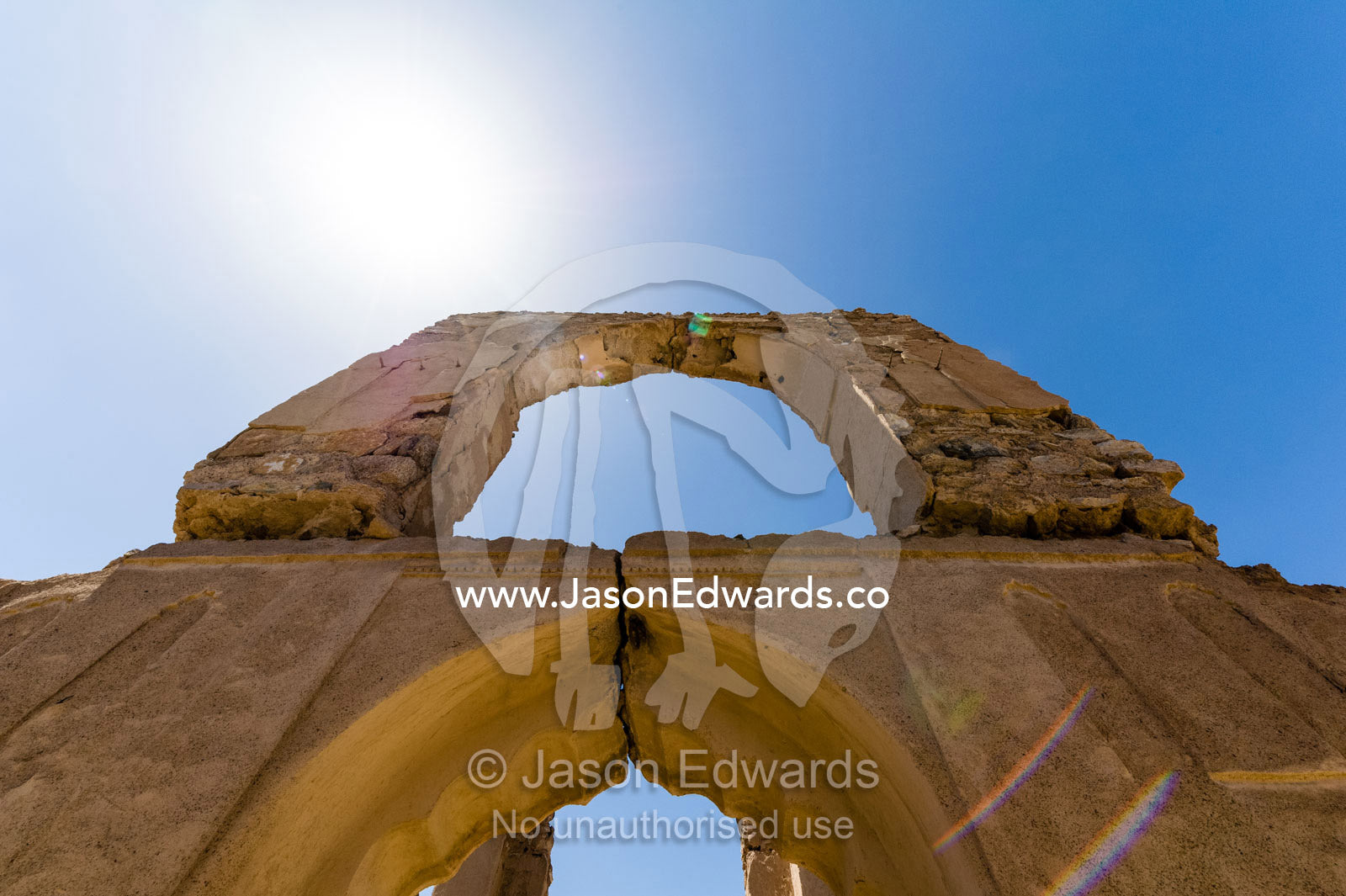 Stone and mud brick archways in an abandoned village in the desert. Ibra, Ash Sharqiyah Region, Sultanate of Oman.
