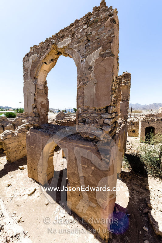 Stone and mud brick archways in an abandoned village in the desert. Ibra, Ash Sharqiyah Region, Sultanate of Oman.