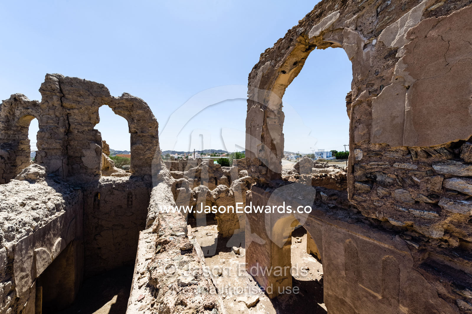 Stone and mud brick archways in an abandoned village in the desert. Ibra, Ash Sharqiyah Region, Sultanate of Oman.