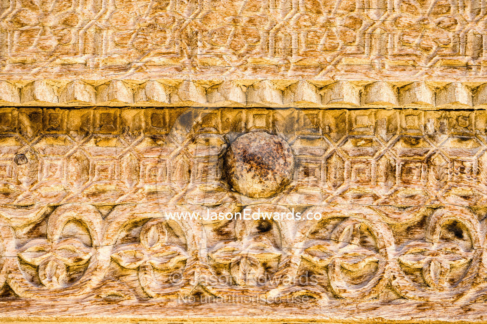 Ornate carving in the timber door frame of a home in an ancient desert village. Ibra, Ash Sharqiyah Region, Sultanate of Oman.