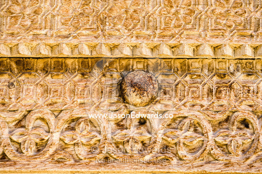 Ornate carving in the timber door frame of a home in an ancient desert village. Ibra, Ash Sharqiyah Region, Sultanate of Oman.