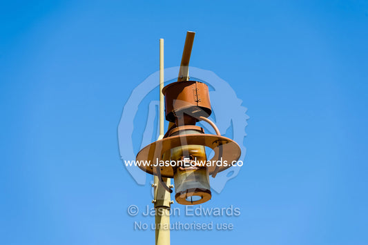 An antique rusting lantern atop a light pole in an abandoned village. Ibra, Ash Sharqiyah Region, Sultanate of Oman.
