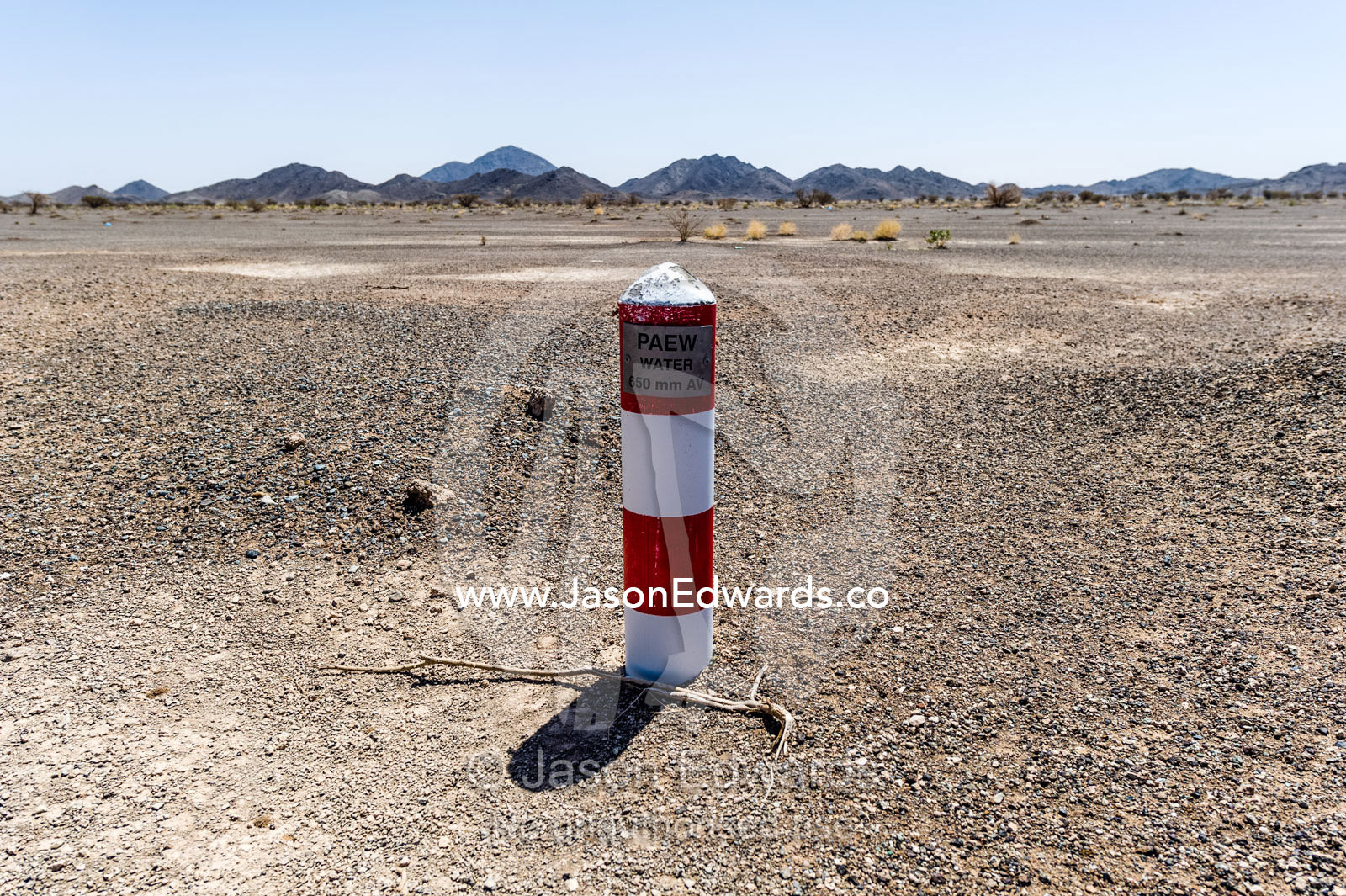A well marker indicates where water is close to the desert surface in an aquaduct. Nizwa, Sultanate of Oman.