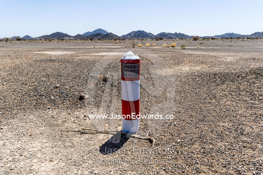 A well marker indicates where water is close to the desert surface in an aquaduct. Nizwa, Sultanate of Oman.