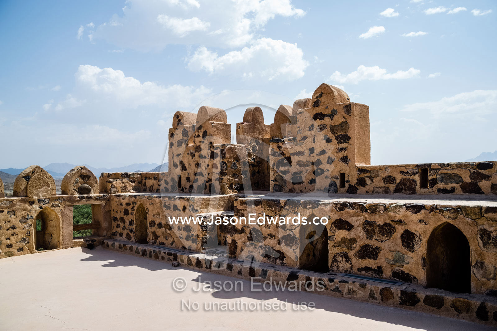 A rooftop courtyard patio exposed to a clear blue sky in an ancient fort. Jabrin Fort, Ad Dakhiliyah Governorate, Sultanate of Oman.