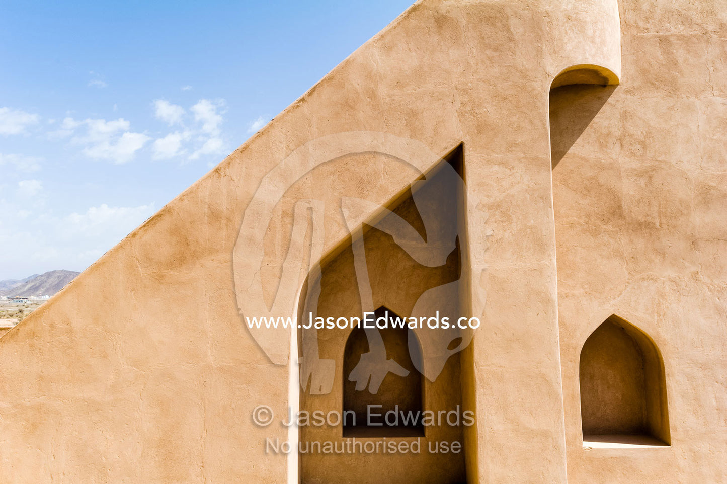 Alcoves for supporting lanterns in the smooth architecture of a stairwell wall in an ancient fort. Jabrin Fort, Ad Dakhiliyah Governorate, Sultanate of Oman.
