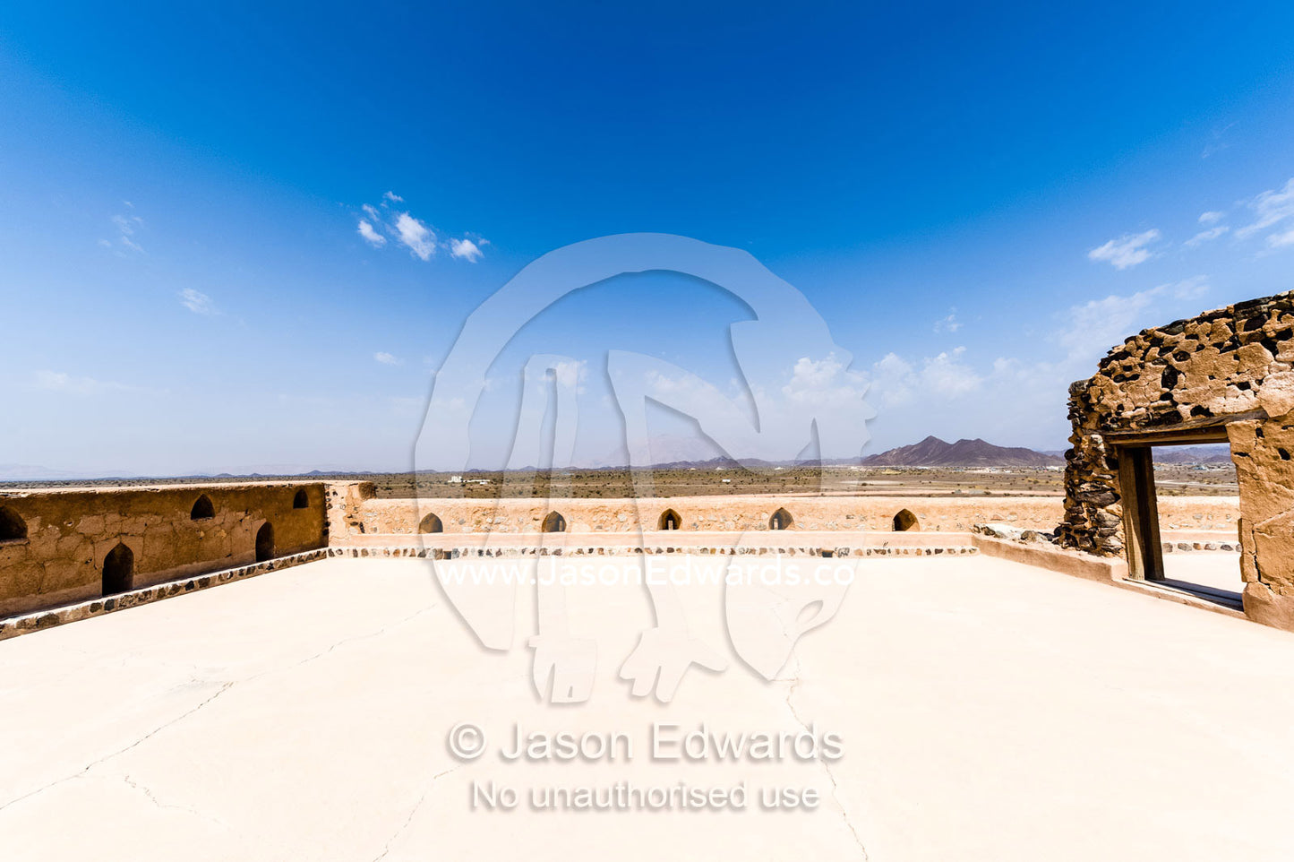 A rooftop courtyard patio exposed to a clear blue sky in an ancient fort. Jabrin Fort, Ad Dakhiliyah Governorate, Sultanate of Oman.