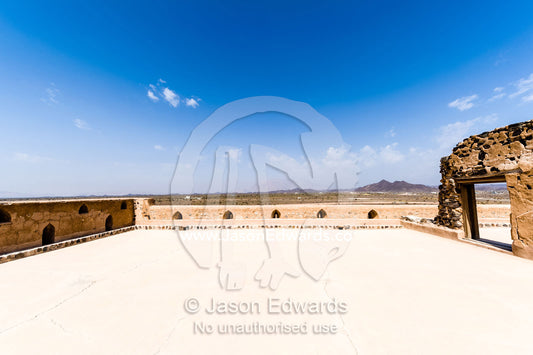 A rooftop courtyard patio exposed to a clear blue sky in an ancient fort. Jabrin Fort, Ad Dakhiliyah Governorate, Sultanate of Oman.
