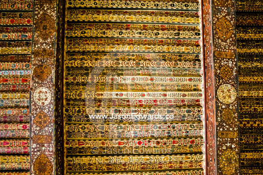 An ancient timber ceiling decorated in ornate paintings and filligree in the Majlis of an ancient fort. Jabrin Fort, Ad Dakhiliyah Governorate, Sultanate of Oman.