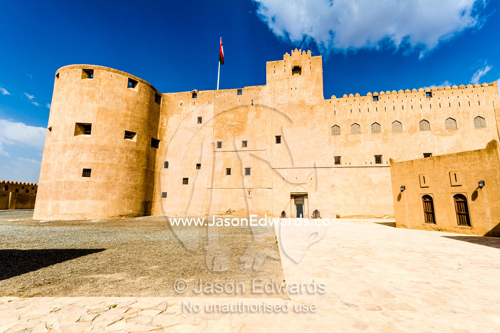 A vast forecourt surrounded by imposing walls and watchtowers in an ancient fort. Jabrin Fort, Ad Dakhiliyah Governorate, Sultanate of Oman.