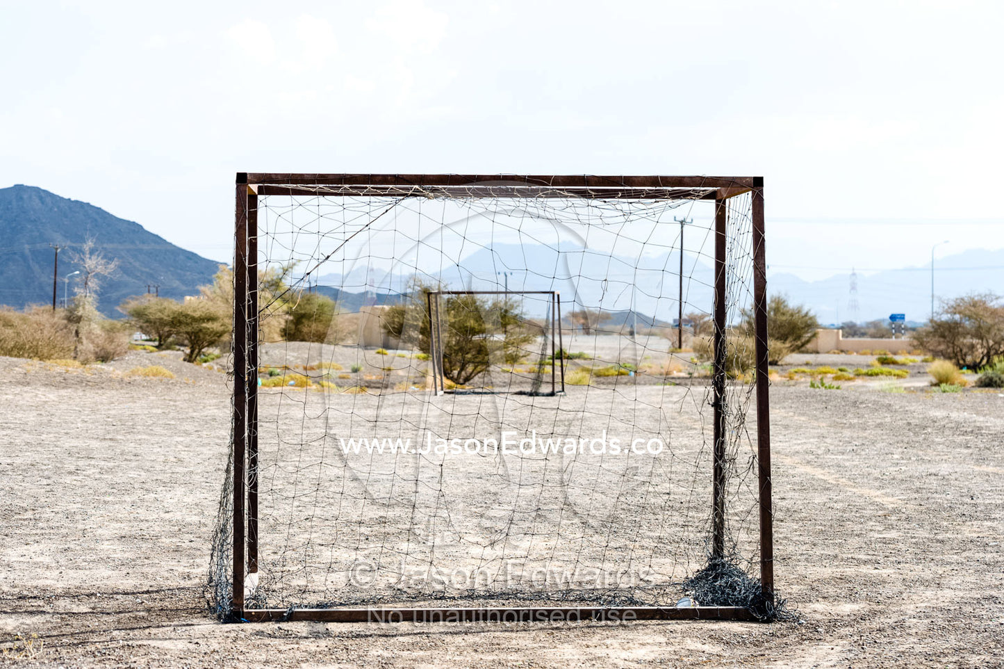 Wornout football nets on a dusty desert field. Jabrin Fort, Ad Dakhiliyah Governorate, Sultanate of Oman.
