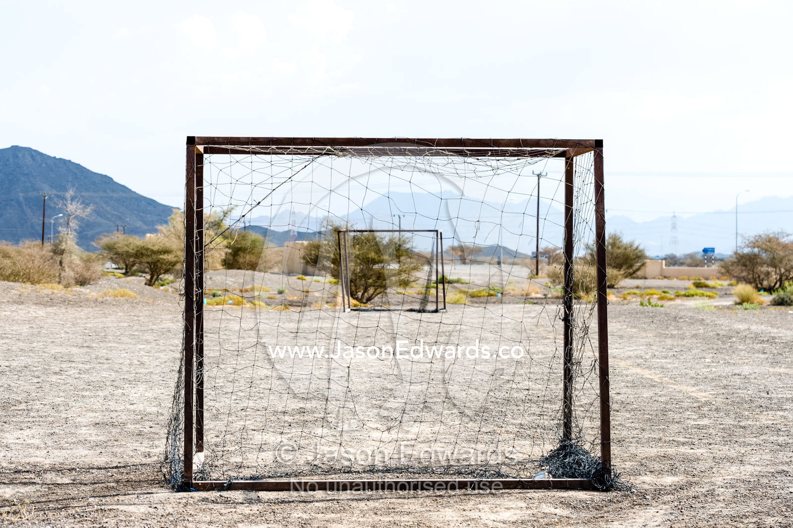 Wornout football nets on a dusty desert field. Jabrin Fort, Ad Dakhiliyah Governorate, Sultanate of Oman.