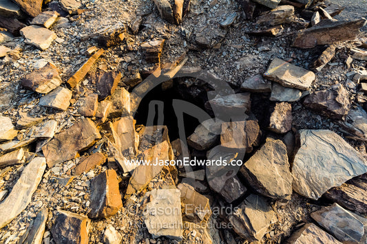The entrance to an ancient handmade stone burial mound and tomb atop a desert ridge. Archaeological Sites of Bat, Al-Ayn, Al Dhahira Region, Sultanate of Oman.