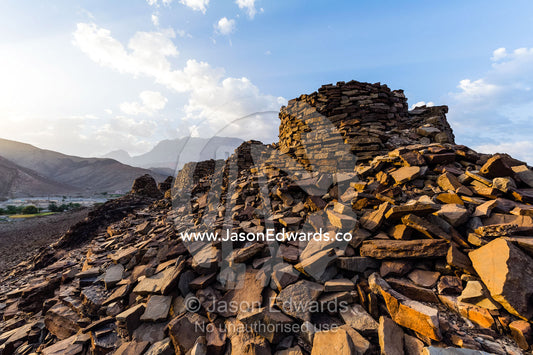 Ancient handmade stone burial mounds and tombs atop a desert ridge. Archaeological Sites of Bat, Al-Ayn, Al Dhahira Region, Sultanate of Oman.