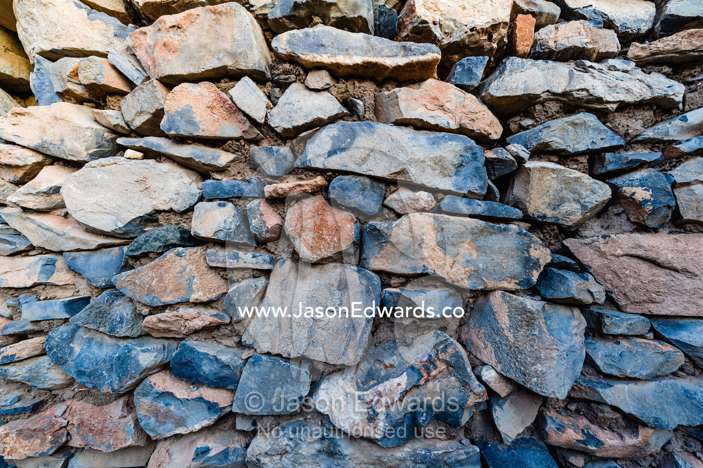 Stacked stones in an ancient handmade building wall in an abandoned desert village house. Wadi Nakhar, Al Hamra, Ad Dakhiliyah Region, Sultanate of Oman.