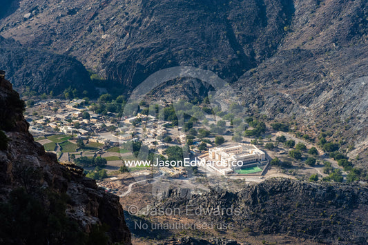 A village nestled at the base of a steep desert valley. Hatt, Wadi Bani Awf, Snake Gorge, Western Hajar Mountains, Ad Dakhiliyah Region, Sultanate of Oman.