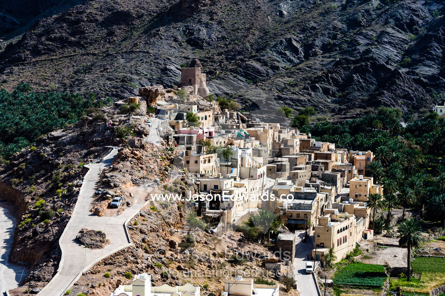 A mountain village stacked on terraced streets in a desert mountain valley. Balad Sayt, Wadi Bani Awf, Snake Gorge, Western Hajar Mountains, Ad Dakhiliyah Region, Sultanate of Oman.