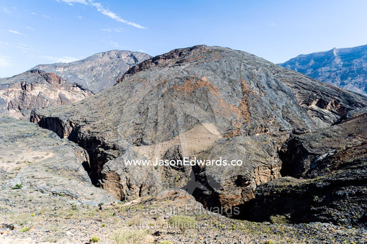 A jagged and winding canyon eroded by a river in a rocky desert. Wadi Bani Awf, Snake Gorge, Western Hajar Mountains, Ad Dakhiliyah Region, Sultanate of Oman.