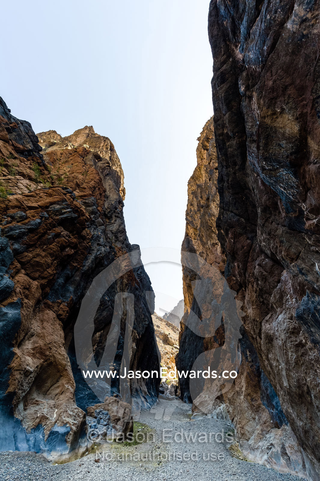 Erosion has carved a deep gorge in a desert mountain pass. Wadi Bani Awf, Snake Gorge, Western Hajar Mountains, Ad Dakhiliyah Region, Sultanate of Oman.