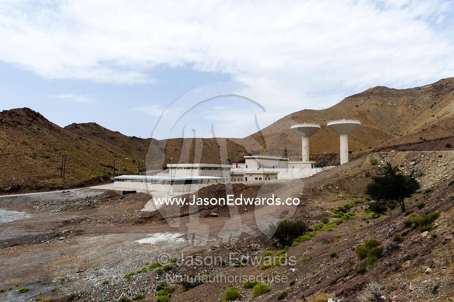 A water catchment dam in a desert valley provides water for a nearby town. Dima Wal Taeen, North Al Sharqiyah Governorate, Sultanate of Oman.