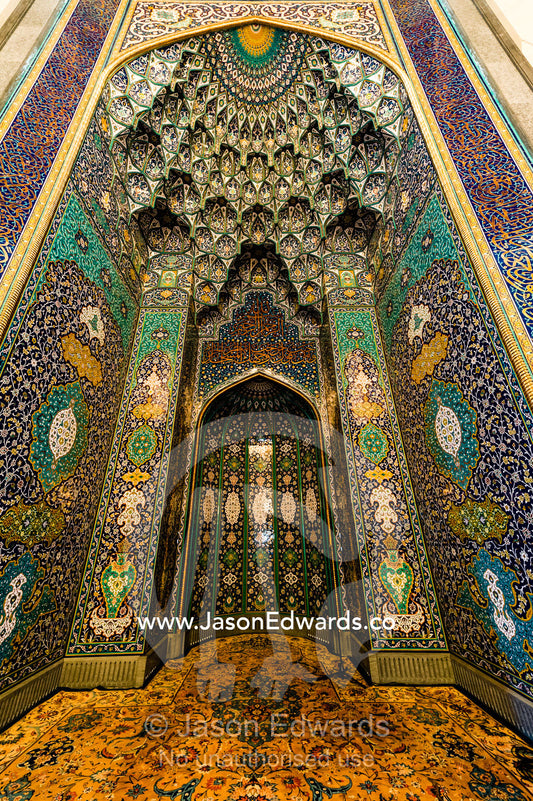 The gold embossed and ornately decorated mihrab in the Prayer Hall of the Grand Mosque. Sultan Qaboos Grand Mosque, Muscat, Sultanate of Oman.