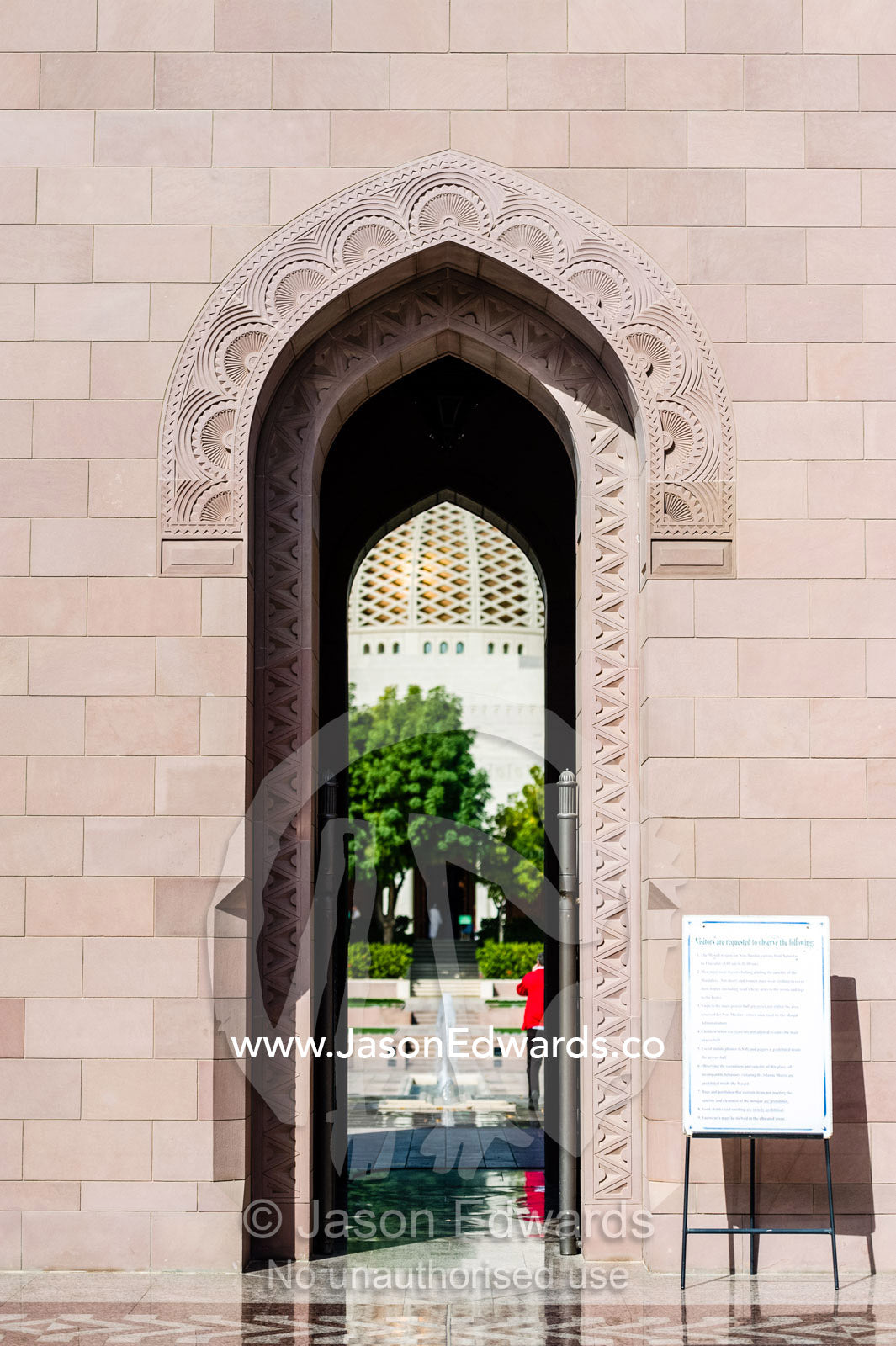 A sign specifies etiquette and rules for visitors to the Grand Mosque. Sultan Qaboos Grand Mosque, Muscat, Sultanate of Oman.