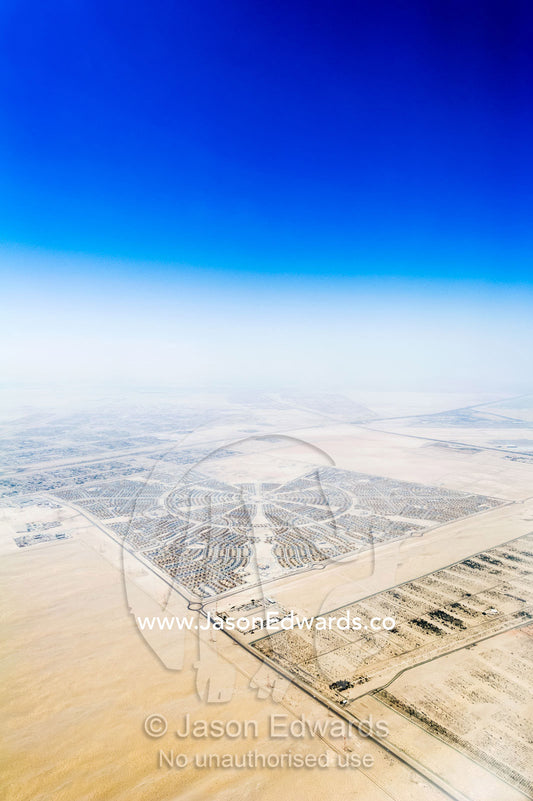 Suburban residential estates surrounded by vast desert sands. Emirate of Abu Dhabi, Abu Dhabi, Persian Gulf, United Arab Emirates.