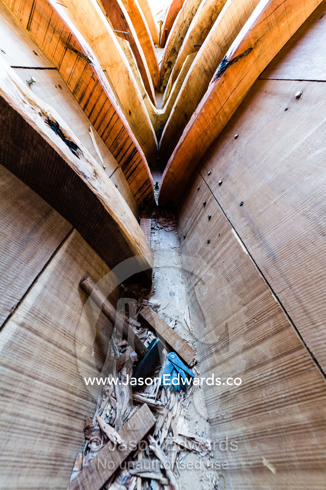 Hammers and chisels inside the timber hull of a dhow during construction. Sur, Ash Sharqiyah Region, Gulf of Oman, Sultanate of Oman.