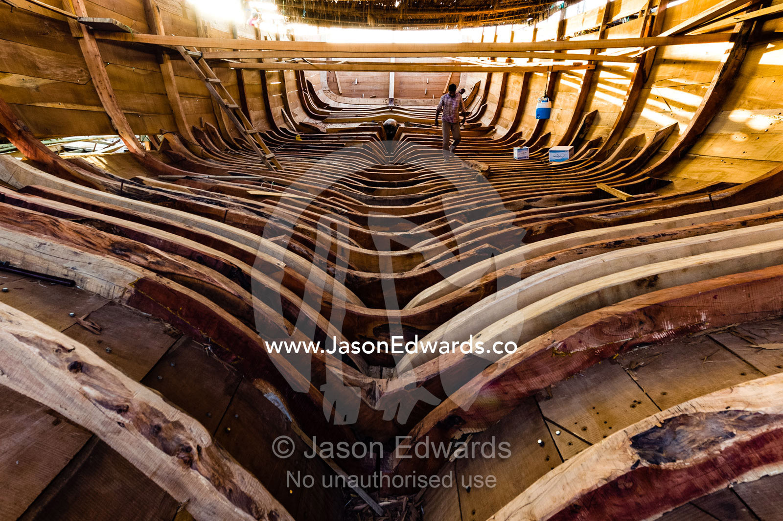 The timber ribs of a wooden dhow hold the planks of the hull in place during construction. Sur, Ash Sharqiyah Region, Gulf of Oman, Sultanate of Oman.