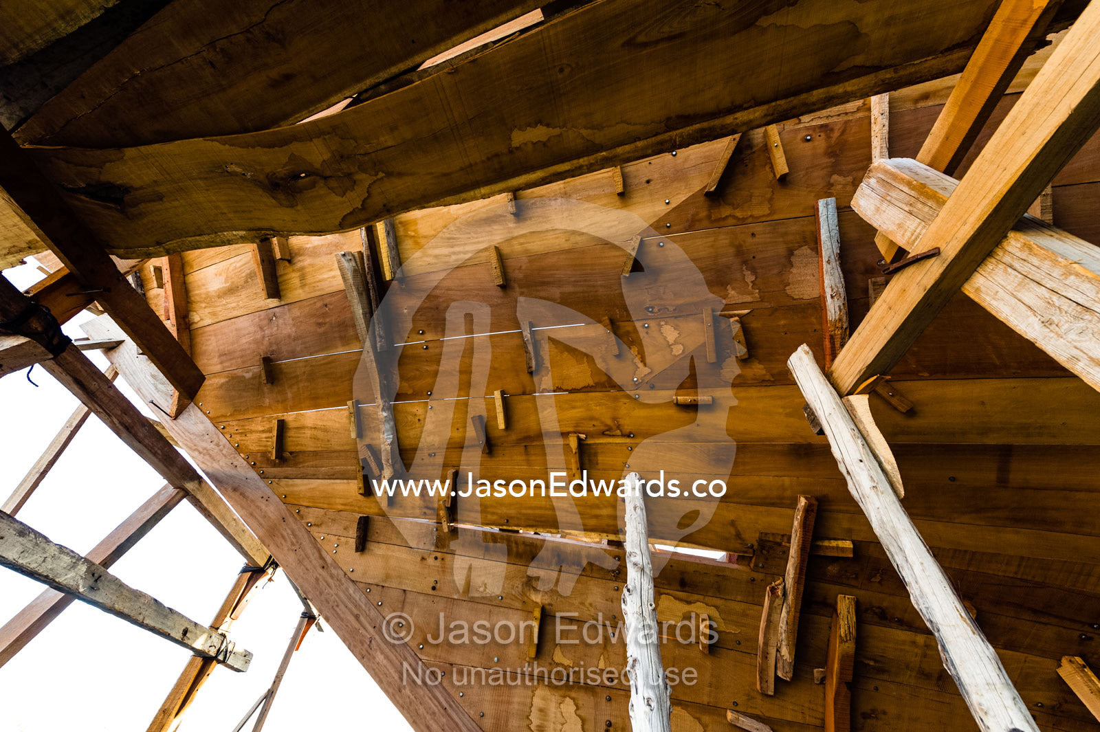 During construction of a dhow, the planks of the hull are held with wooden plugs and scaffolding. Sur, Ash Sharqiyah Region, Gulf of Oman, Sultanate of Oman.