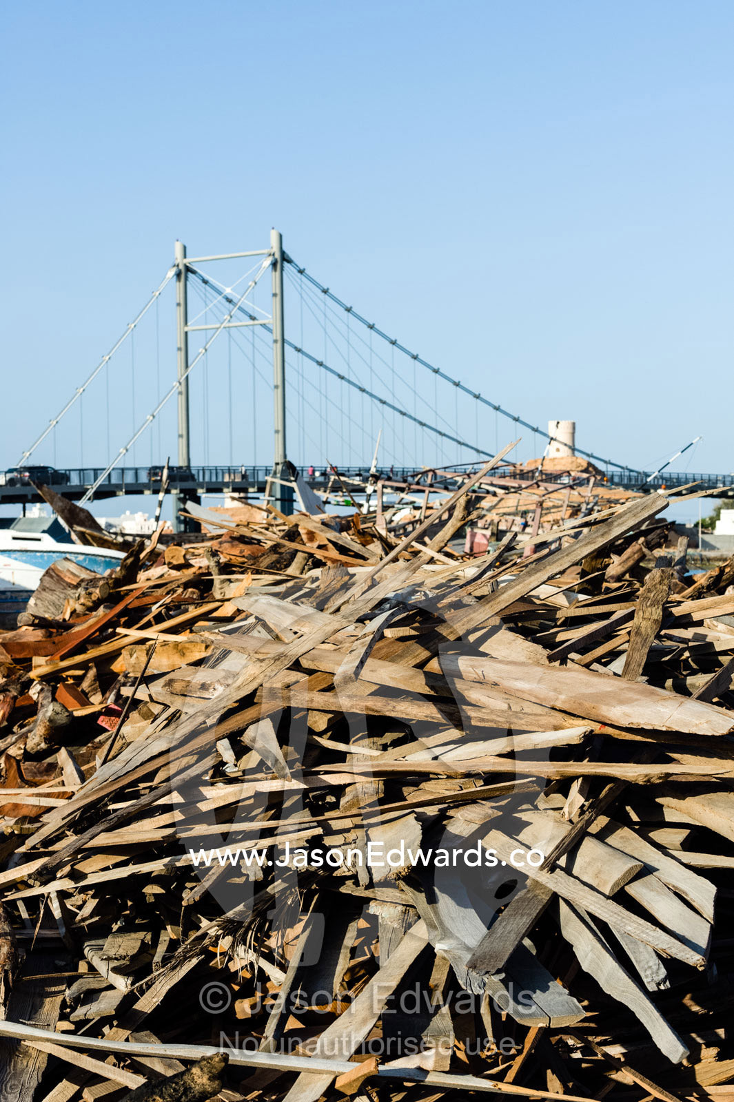 A pile of timber scraps from the construction of ancient dhows in a ship building yard. Sur, Ash Sharqiyah Region, Gulf of Oman, Sultanate of Oman.