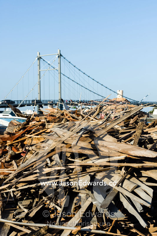 A pile of timber scraps from the construction of ancient dhows in a ship building yard. Sur, Ash Sharqiyah Region, Gulf of Oman, Sultanate of Oman.