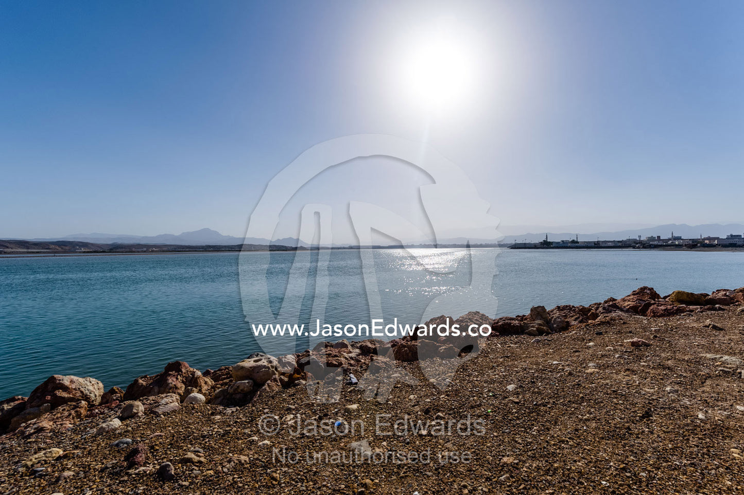 The desert sun warms the ocean on the Gulf of Oman. Sur, Ash Sharqiyah Region, Gulf of Oman, Sultanate of Oman.